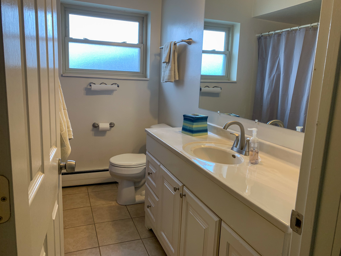 1616 South Mannheim Road Westchester, IL 60154 - Photo 11 of 13 a bathroom with a sink a toilet and mirror