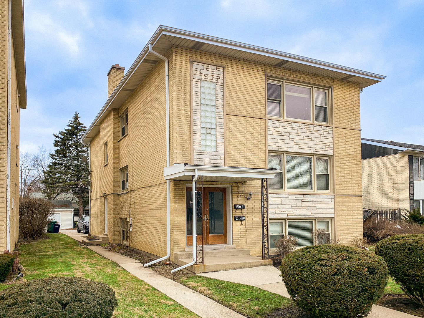 1616 South Mannheim Road Westchester, IL 60154 - Photo 2 of 13 a front view of a house with a yard