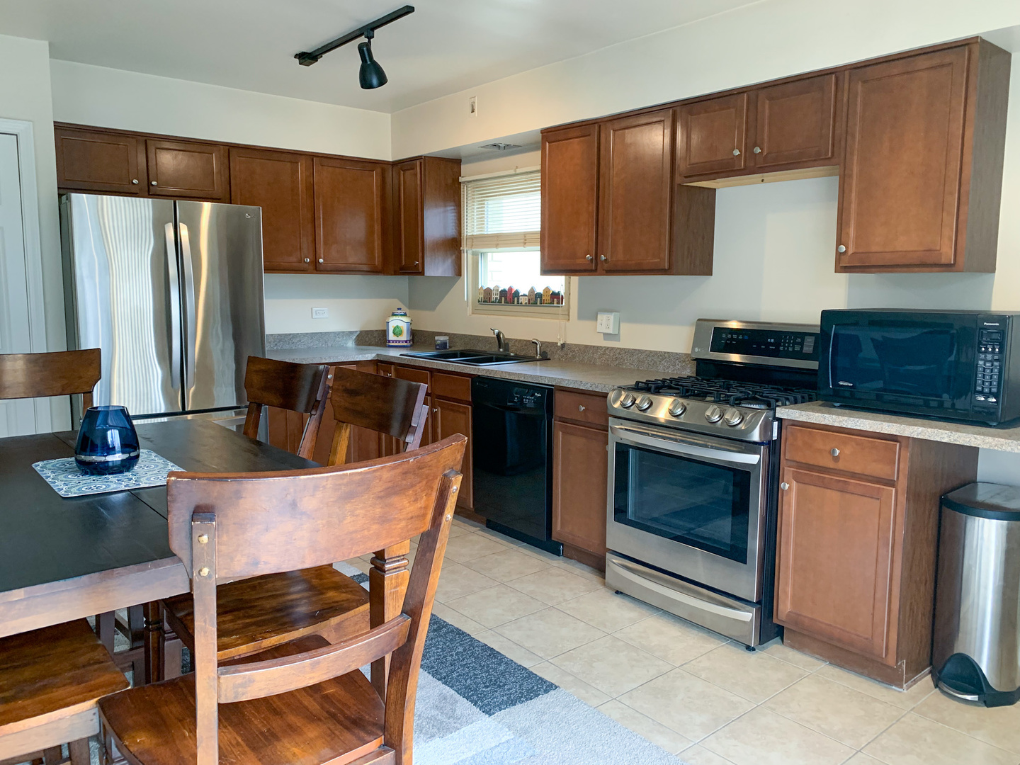 1616 South Mannheim Road Westchester, IL 60154 - Photo 5 of 13 a kitchen with stainless steel appliances granite countertop a stove a sink dishwasher a refrigerator and a microwave