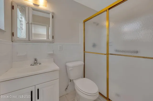 a white toilet sitting next to a bathroom sink