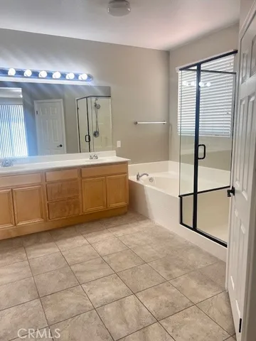 a spacious bathroom with a large tub shower and sink