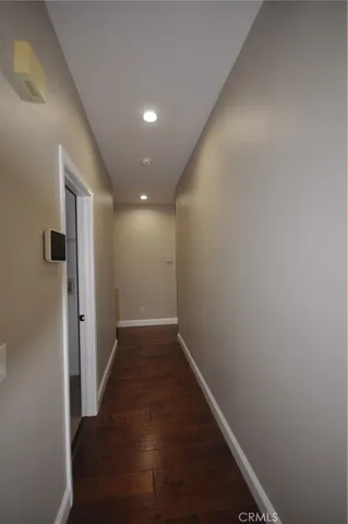 a view of hallway with wooden floor