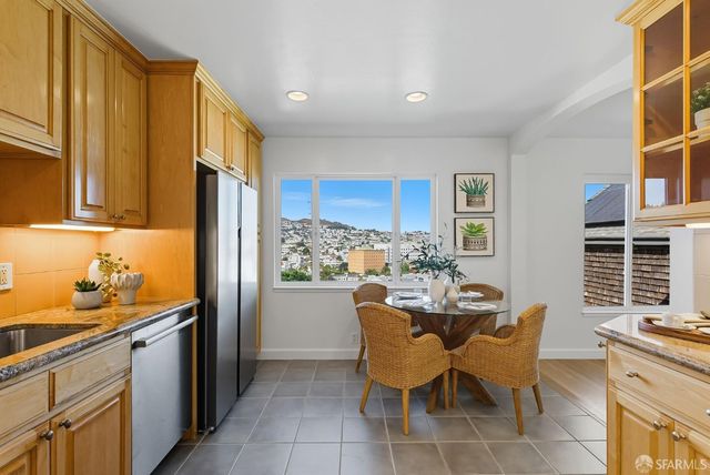 a dining room with furniture and a window
