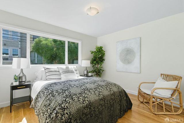 a bedroom with a bed and a chair