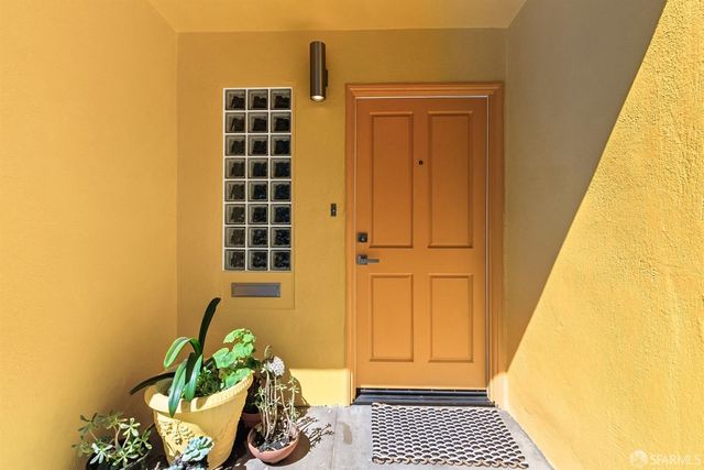 a view of porch with wooden floor and a potted plant