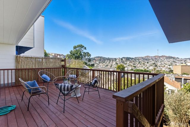 a view of a balcony with outdoor seating