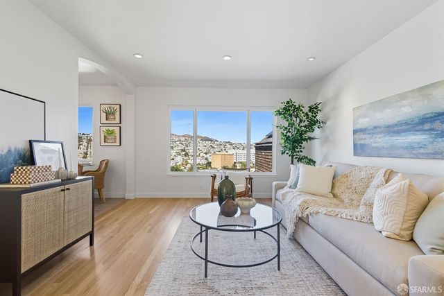 a living room with furniture and painting on the wall