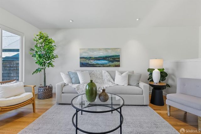 a living room with furniture and a potted plant