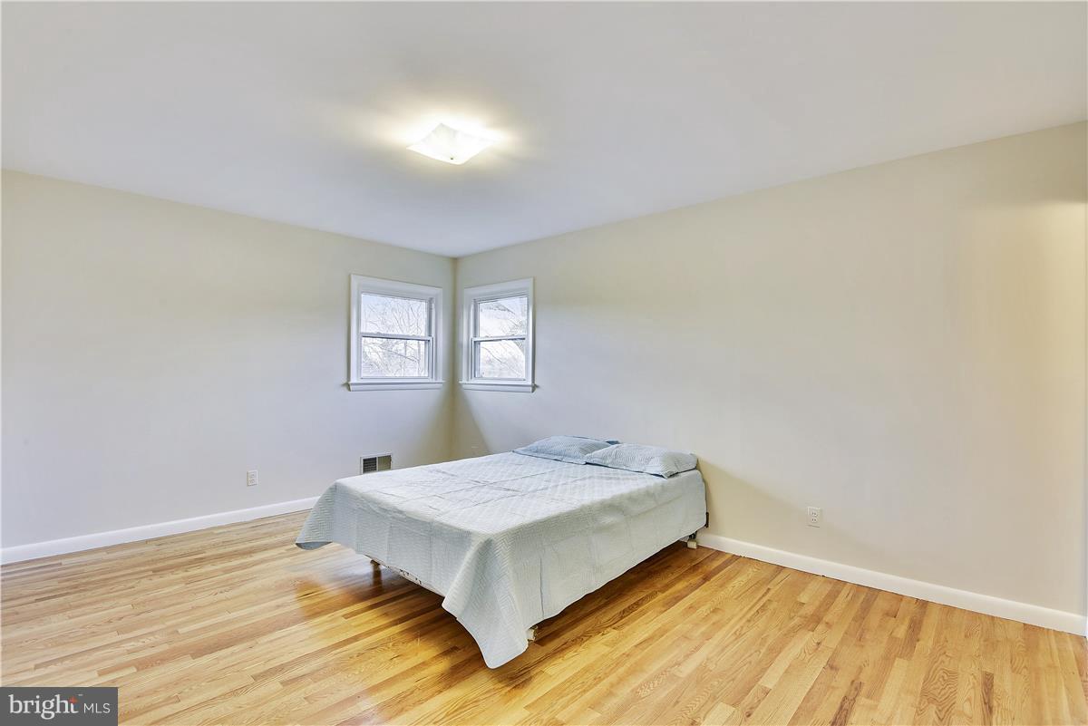 5901 Folkstone Road Bethesda, MD 20817 - Photo 11 of 30 a bedroom with a bed and window
