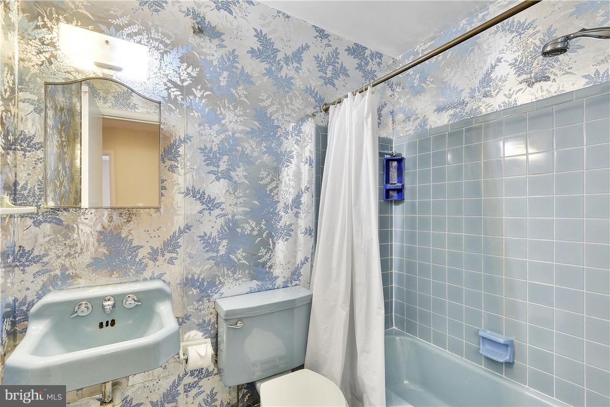 5901 Folkstone Road Bethesda, MD 20817 - Photo 18 of 30 a bathroom with a sink toilet and shower