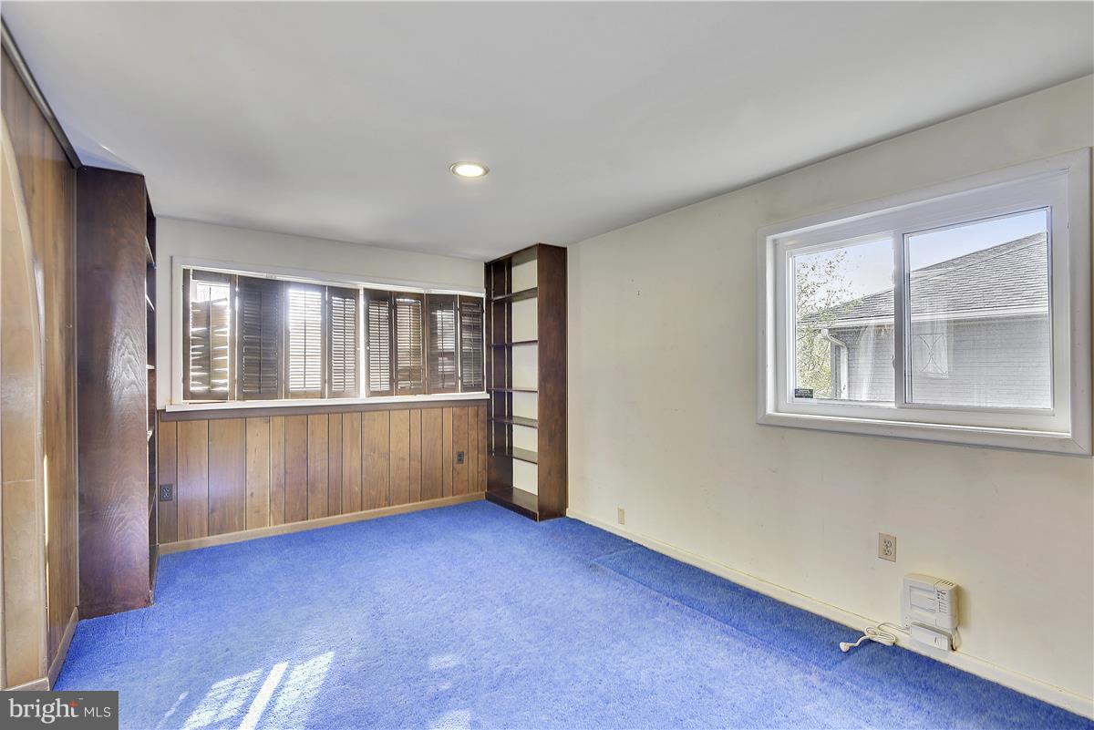 5901 Folkstone Road Bethesda, MD 20817 - Photo 25 of 30 a view of an empty room with a window and wooden floor