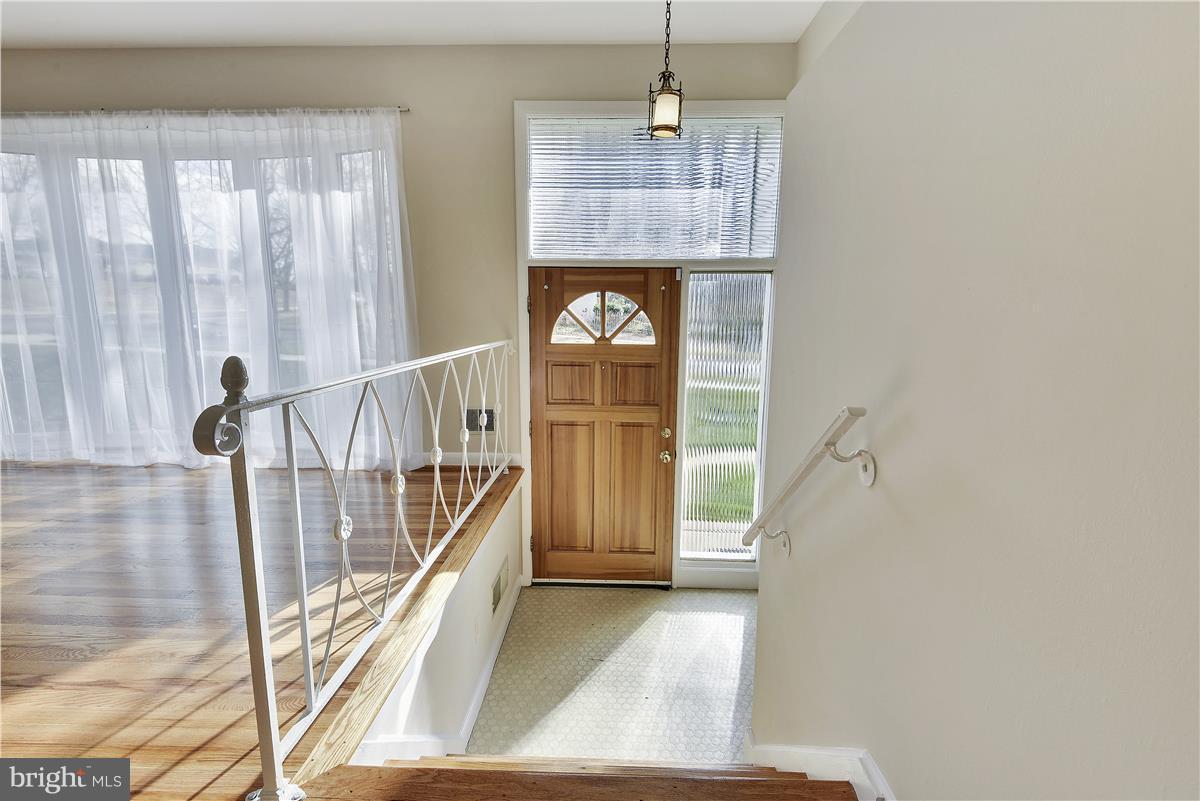 5901 Folkstone Road Bethesda, MD 20817 - Photo 4 of 30 a view of a hallway to rooms and stairs