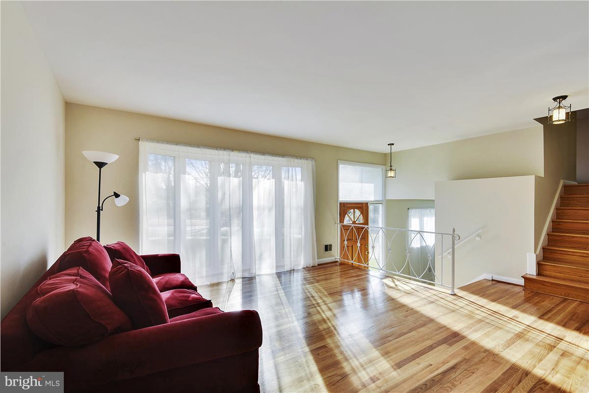 5901 Folkstone Road Bethesda, MD 20817 - Photo 5 of 30 a living room with furniture and a wooden floor