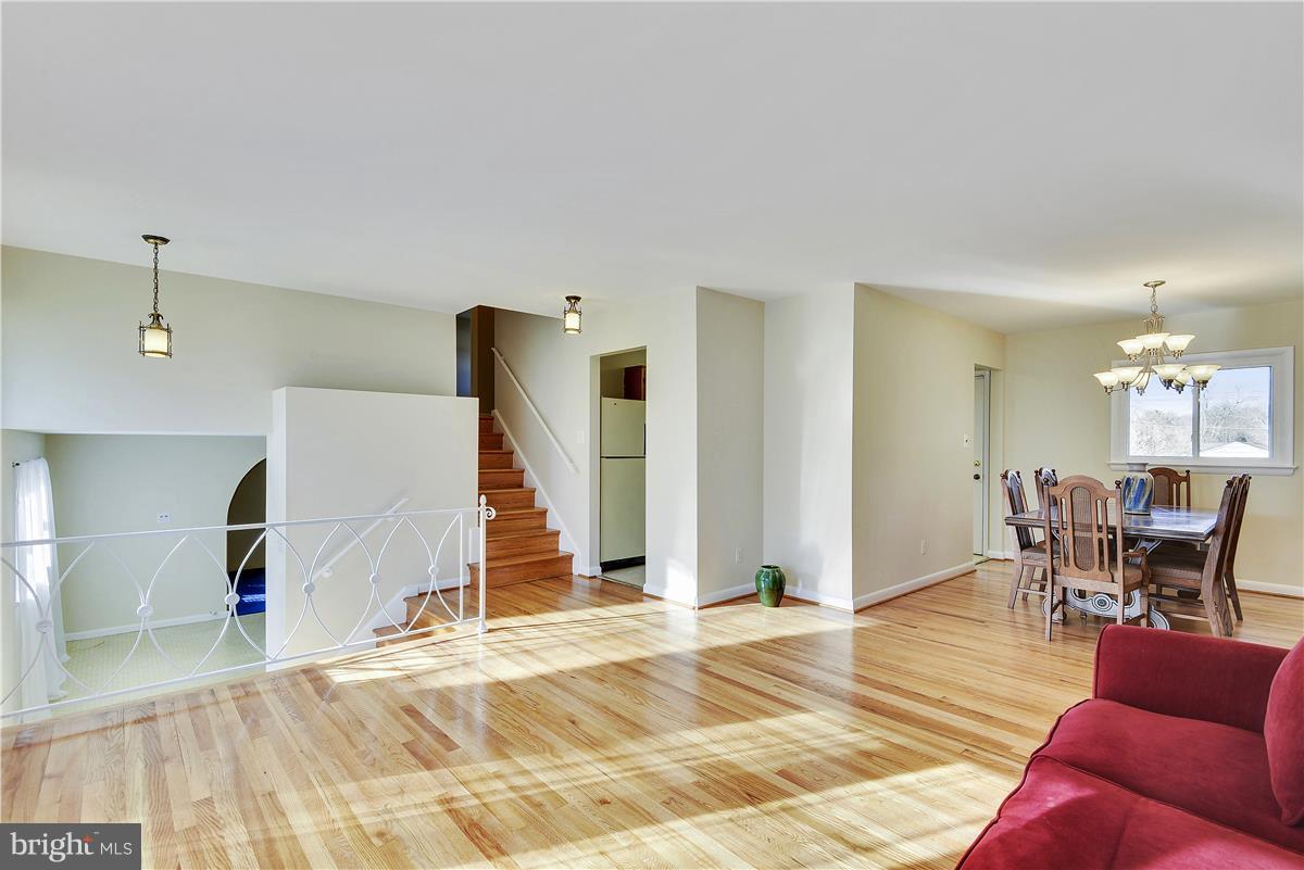 5901 Folkstone Road Bethesda, MD 20817 - Photo 6 of 30 a view of a livingroom with furniture and wooden floor