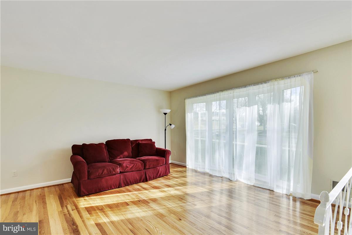 5901 Folkstone Road Bethesda, MD 20817 - Photo 7 of 30 a living room with furniture and a couch
