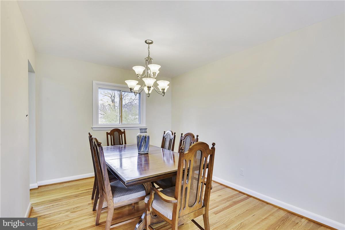 5901 Folkstone Road Bethesda, MD 20817 - Photo 8 of 30 a view of a dining room with furniture and chandelier