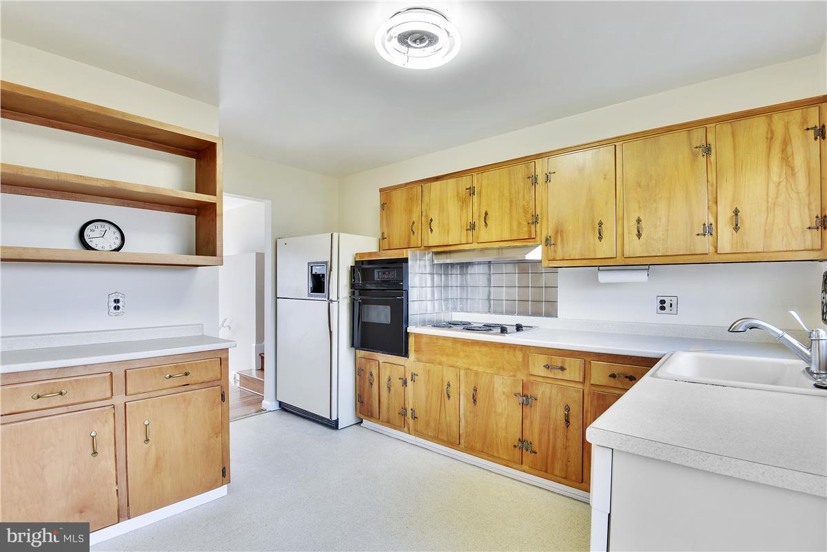 5901 Folkstone Road Bethesda, MD 20817 - Photo 9 of 30 a kitchen with cabinets and appliances