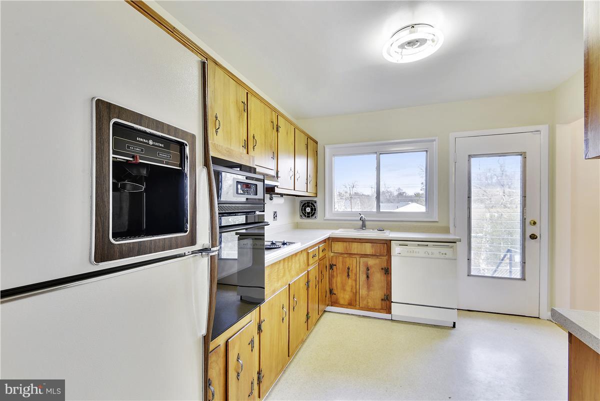 5901 Folkstone Road Bethesda, MD 20817 - Photo 10 of 30 a view of a kitchen with a stove top oven