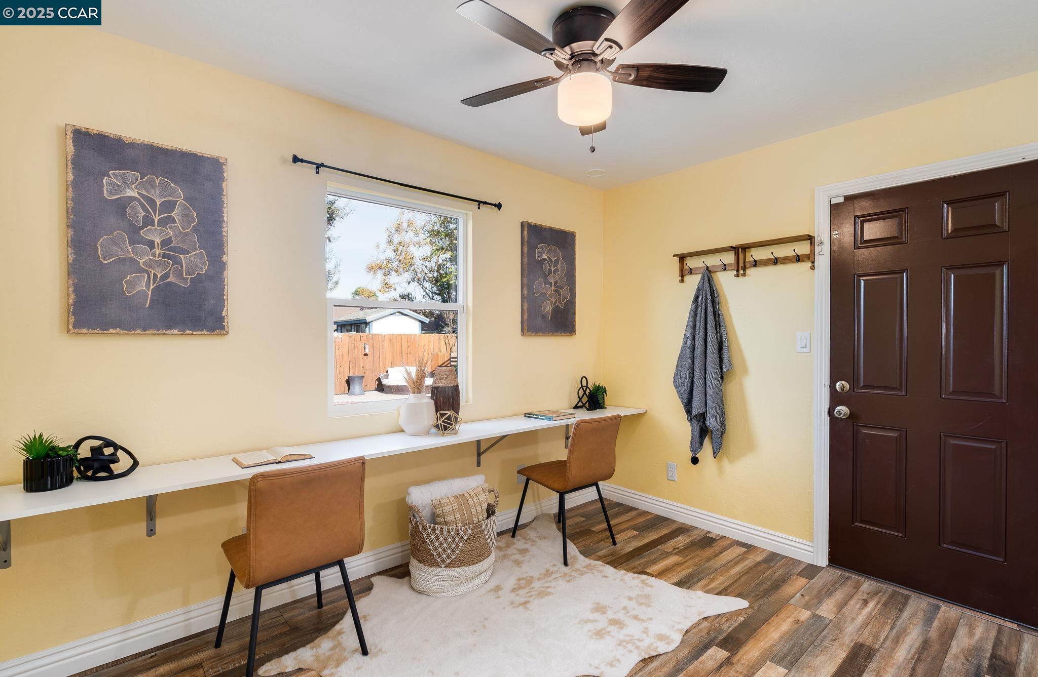 2941 Crawford Street Concord, CA 94518 - Photo 16 of 27 a dining room with wooden floor and a chandelier fan