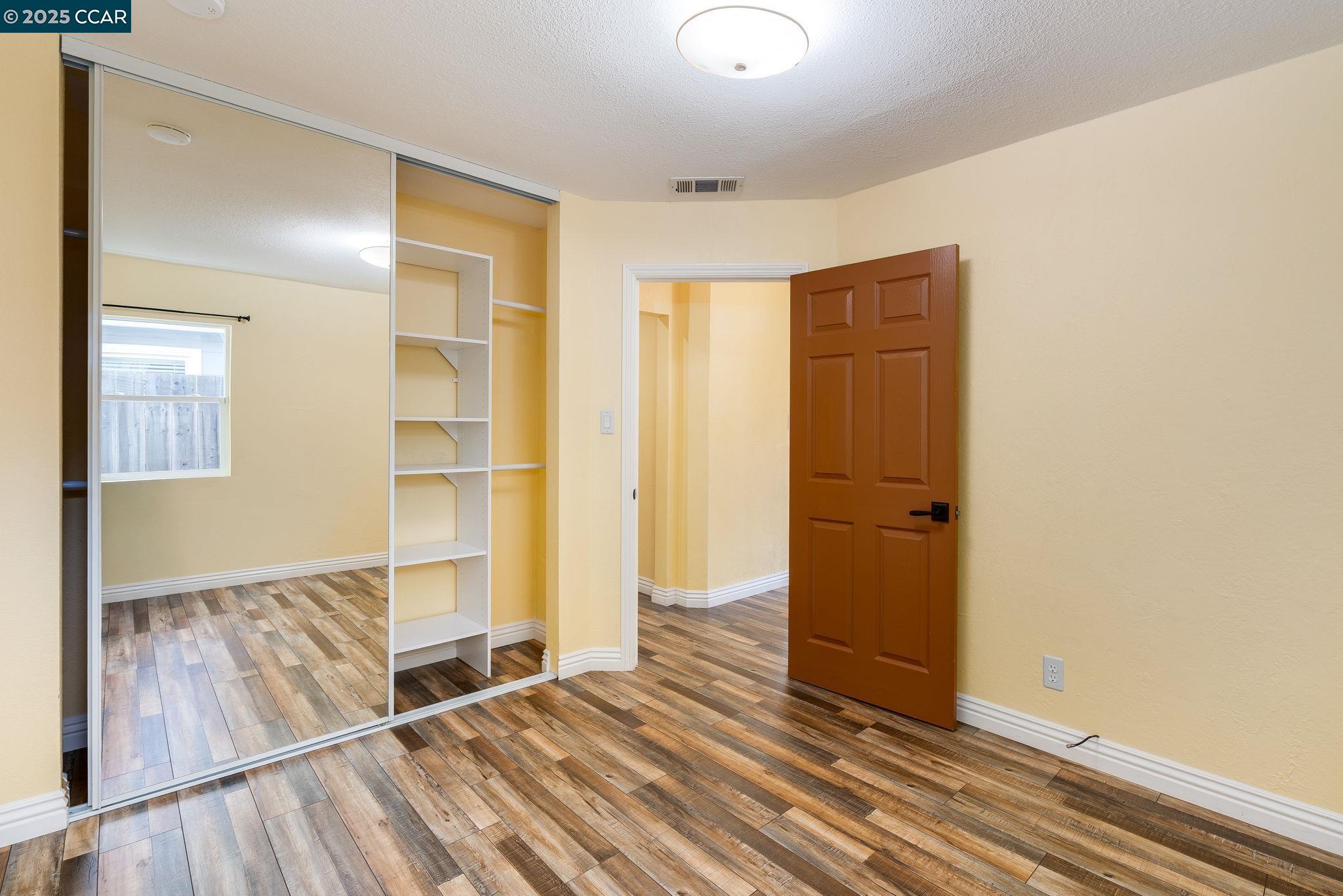 2941 Crawford Street Concord, CA 94518 - Photo 18 of 27 an empty room with wooden floor and a window