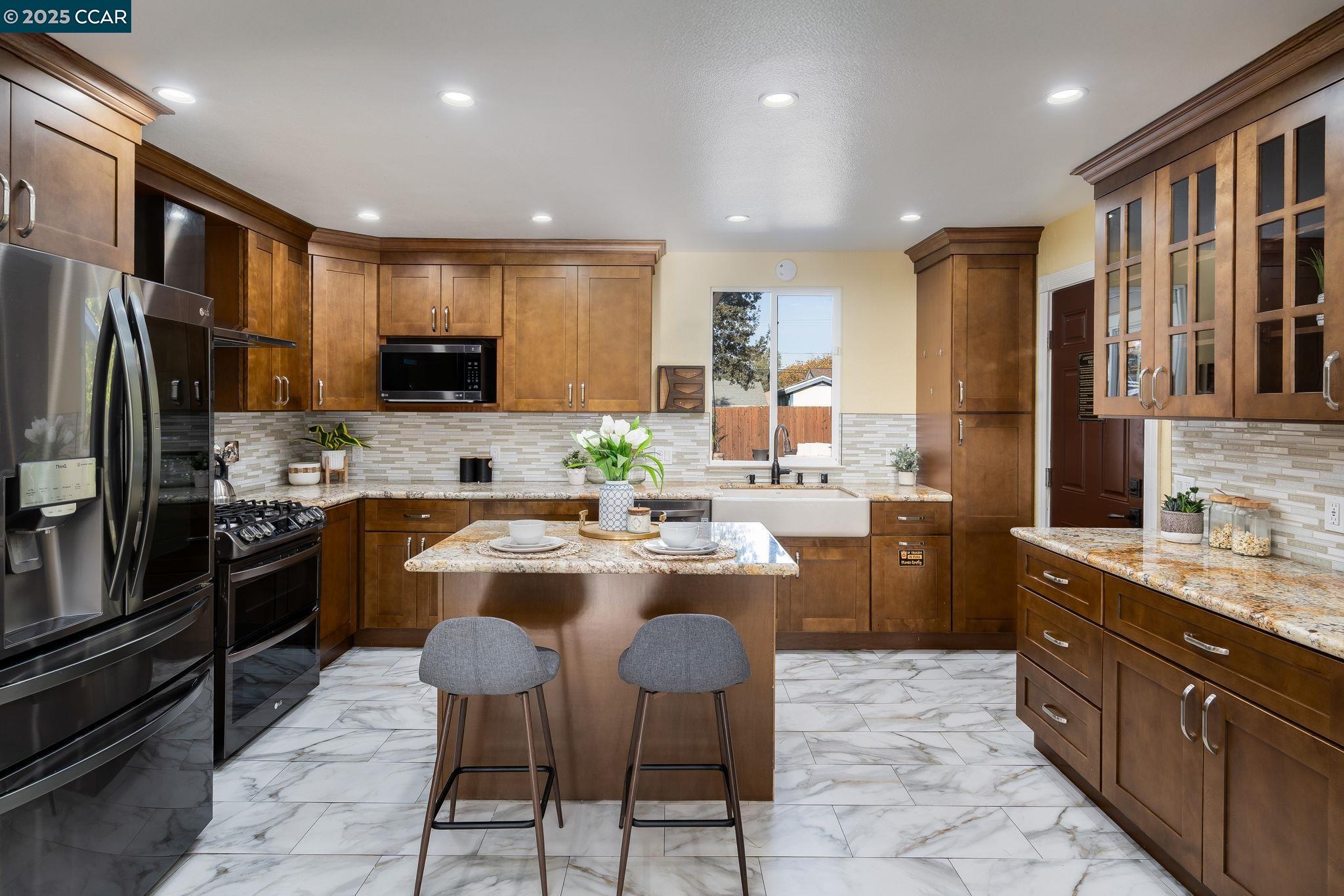 2941 Crawford Street Concord, CA 94518 - Photo 7 of 27 a kitchen with stainless steel appliances kitchen island granite countertop a sink and cabinets