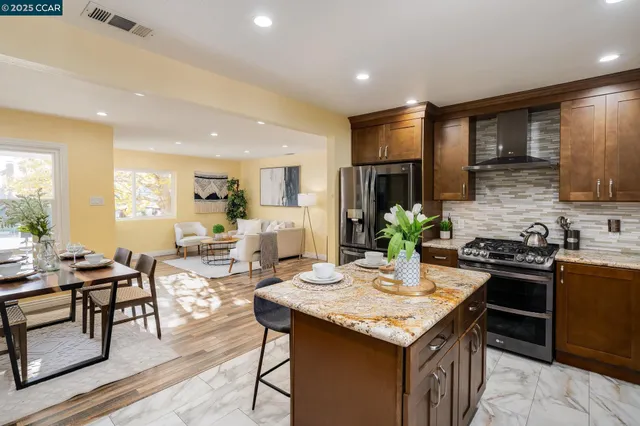 a kitchen that has a table and chairs in it