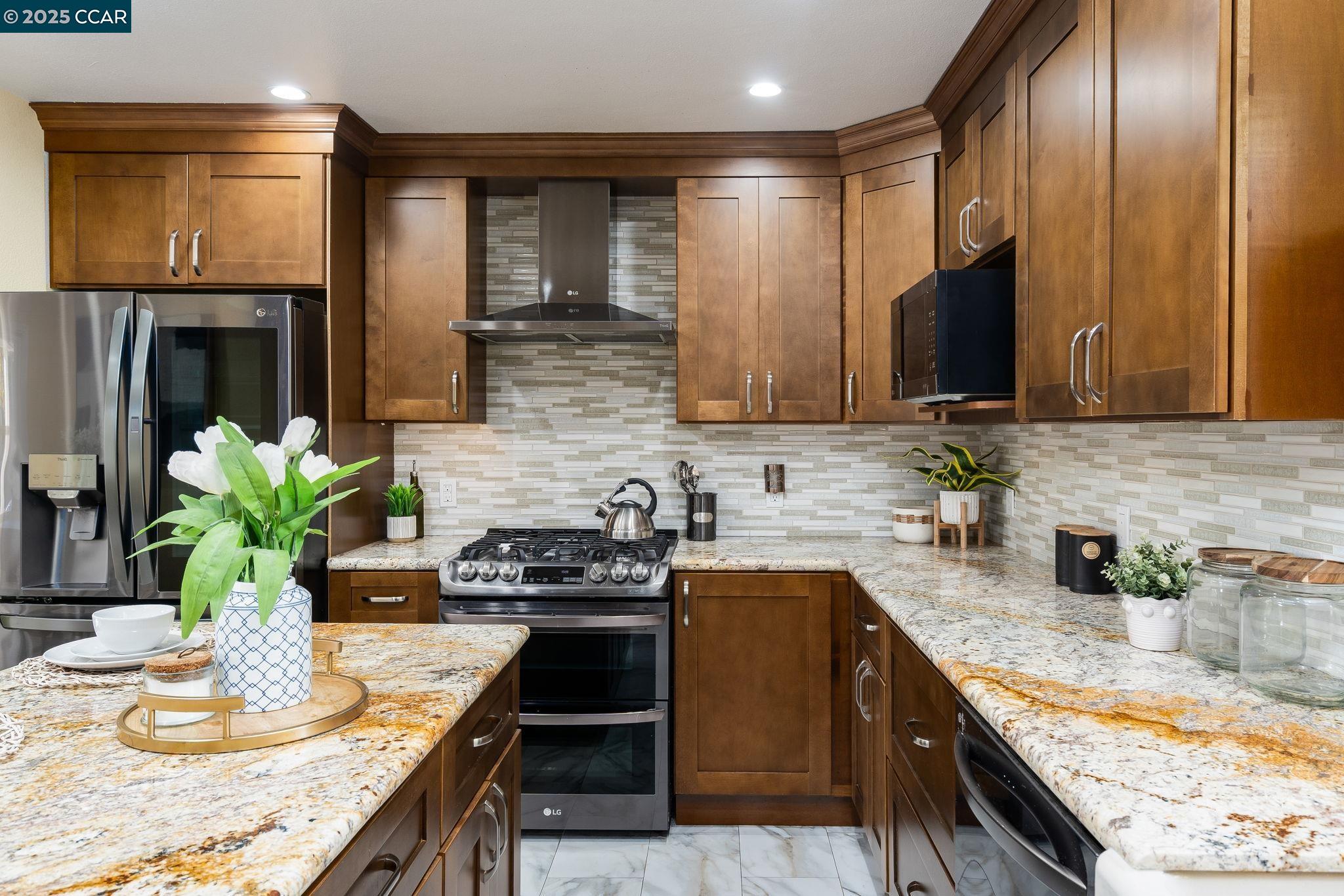 2941 Crawford Street Concord, CA 94518 - Photo 9 of 27 a kitchen with stainless steel appliances granite countertop a sink a stove top oven a counter space and cabinets