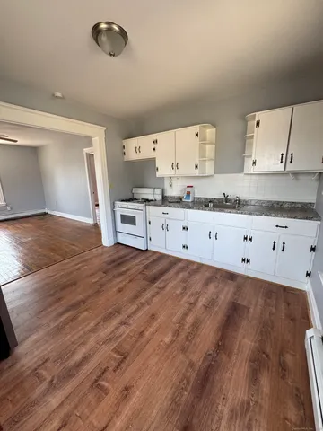 a kitchen with granite countertop a stove and a sink