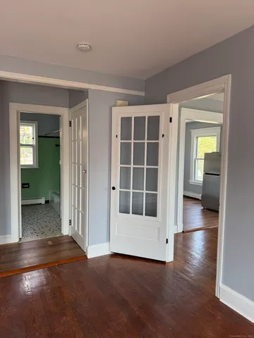 an empty room with windows and entrance