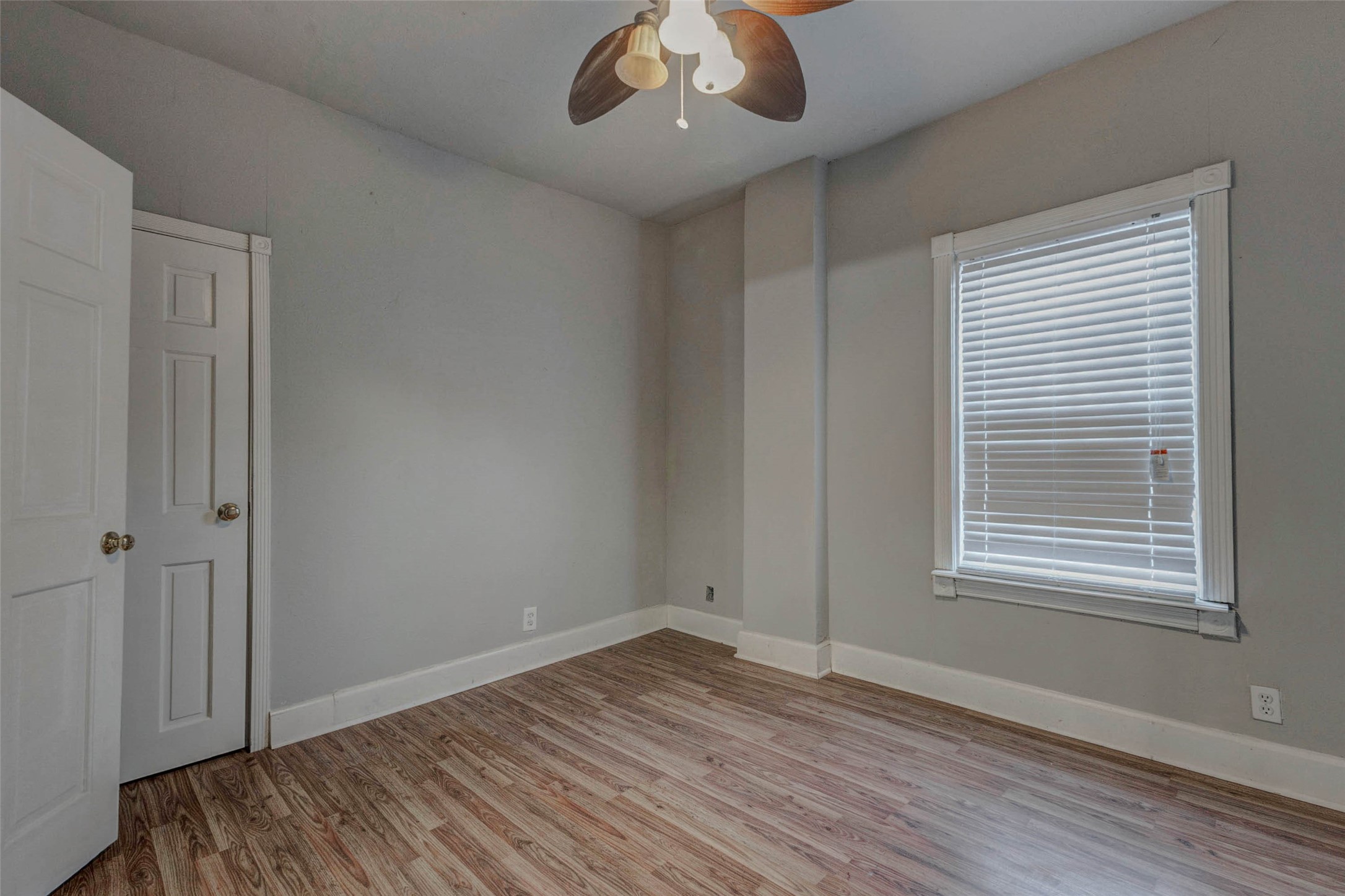 2410 Cleburne Street Houston, TX 77004 - Photo 12 of 27 a view of an empty room with wooden floor and a window