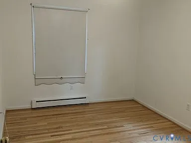 an empty room with wooden floor