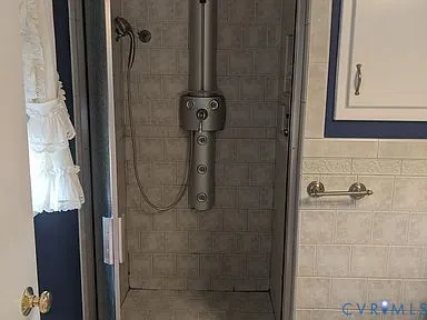 a bathroom with a glass shower door