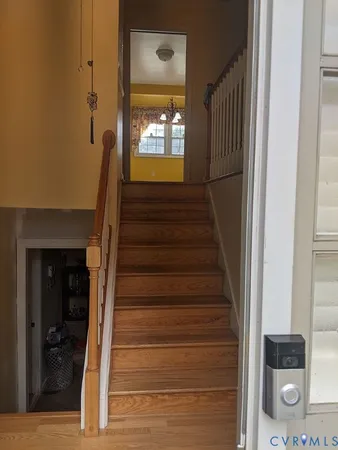 a view of entryway and hall with wooden floor