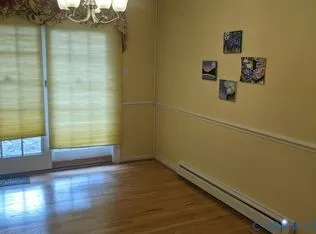 a view of a small space with wooden floor and a window
