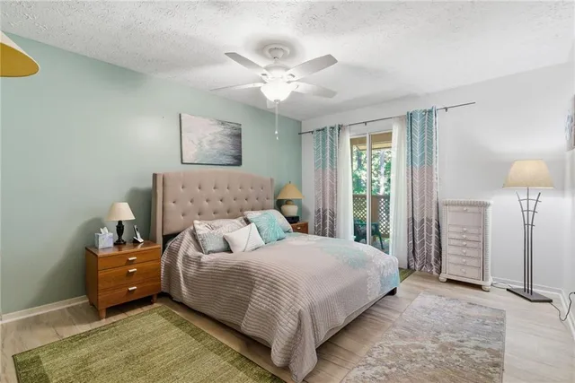 a bedroom with a large bed and a chandelier