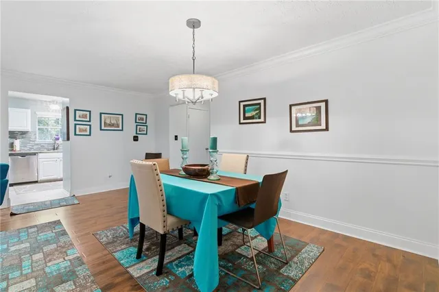 a view of a dining room with furniture wooden floor and a chandelier