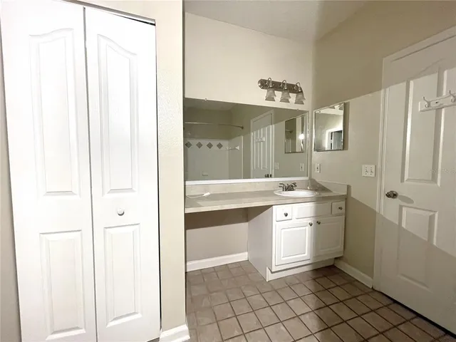 a spacious bathroom with a shower and a sink