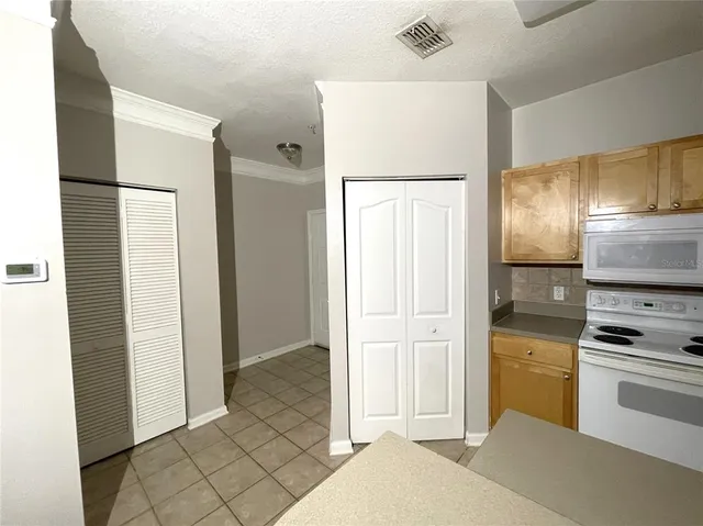 a kitchen with stainless steel appliances a refrigerator and a stove top oven