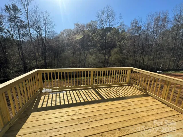 a view of balcony with wooden floor and fence