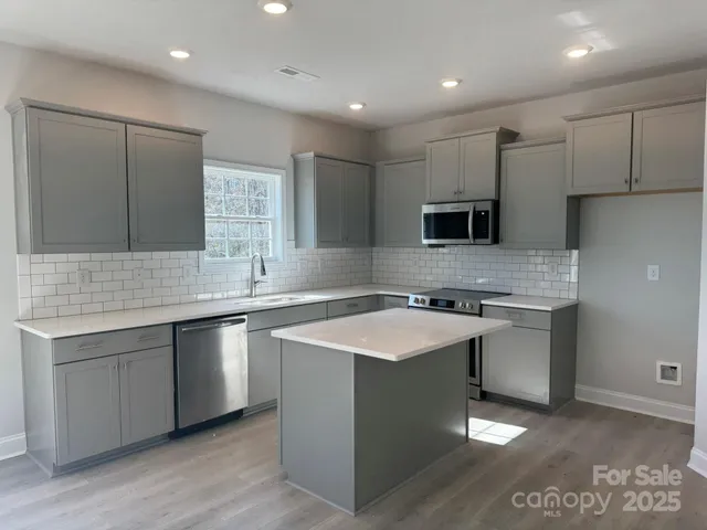 a kitchen with a sink stove and refrigerator
