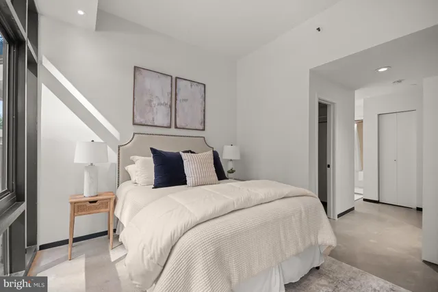 a bedroom with a bed and a large mirror