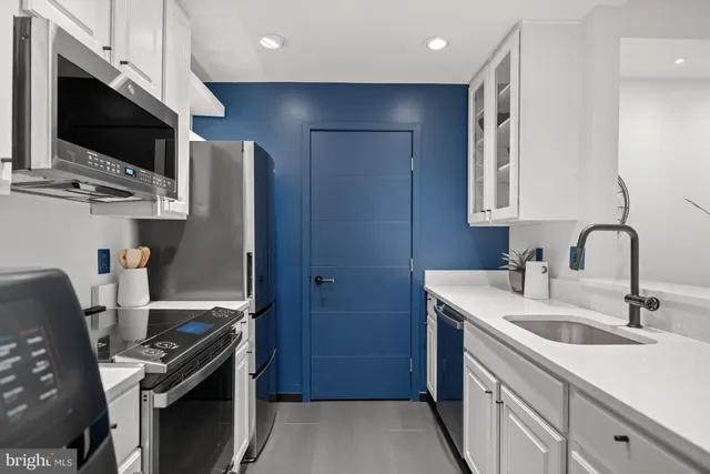 a kitchen with stainless steel appliances a sink stove and refrigerator