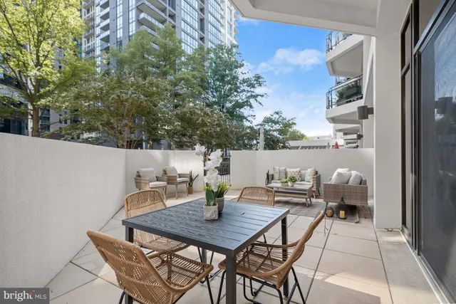 a view of a patio with a table and chairs