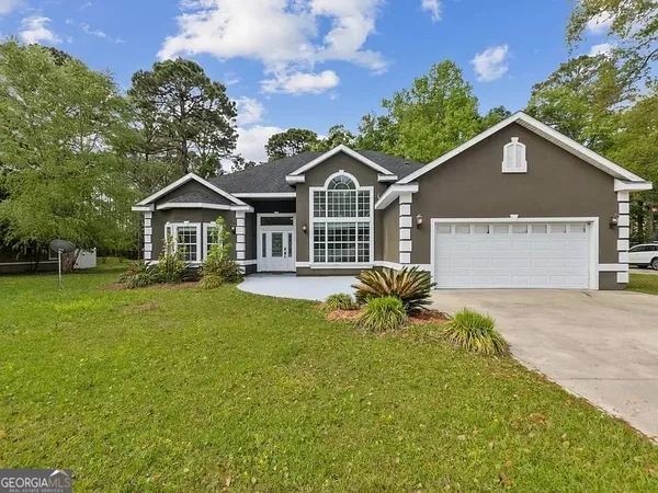 a front view of a house with a garden