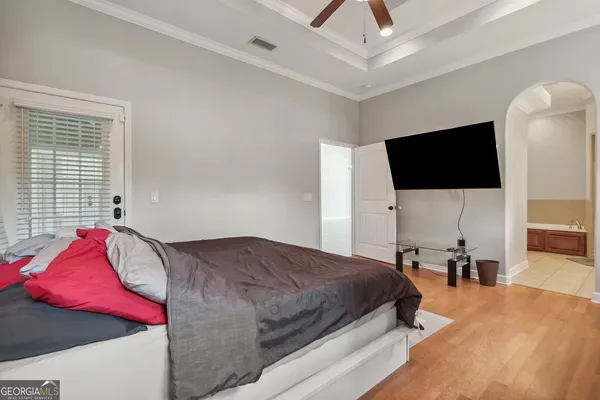 a bedroom with a bed and a flat screen tv