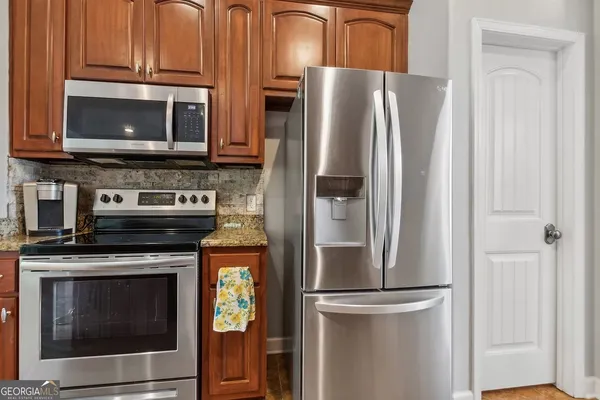a kitchen with stainless steel appliances and cabinets
