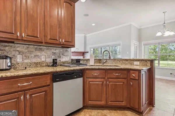 a kitchen with granite countertop stainless steel appliances sink and cabinets