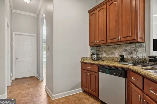 a kitchen with stainless steel appliances granite countertop a refrigerator and a sink