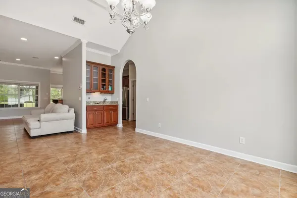 a living room with furniture and a chandelier