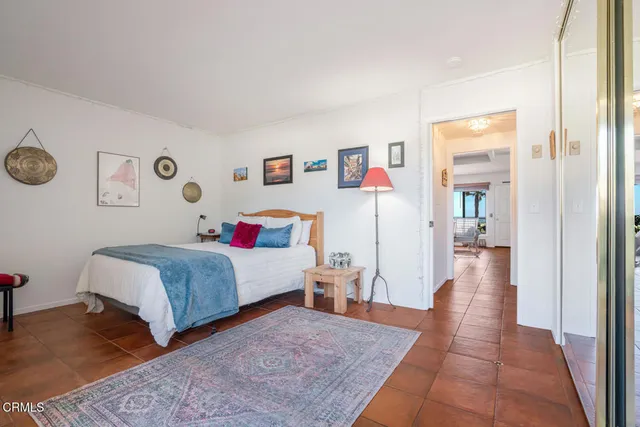 a bedroom with a bed and painting on the wall